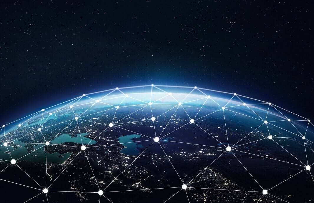View of Earth from space at night with interconnected dots forming a network pattern across the globe, representing global connectivity, much like managed web hosting seamlessly linking WordPress sites worldwide.